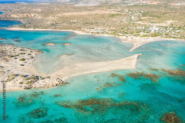 Fototapeta The sandy beach and its heavenly colored water, in Europe, Greece, Crete, Elafonisi, By the Mediterranean Sea, in summer, on a sunny day.