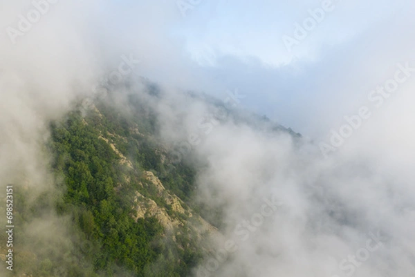 Obraz The green countryside under the clouds in Europe, France, in the Pyrenees, in summer, on a sunny day.