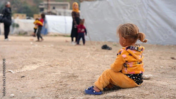 Fototapeta World Refugee Day. Syrian refugee children suffer from tragic humanitarian conditions in winter. 