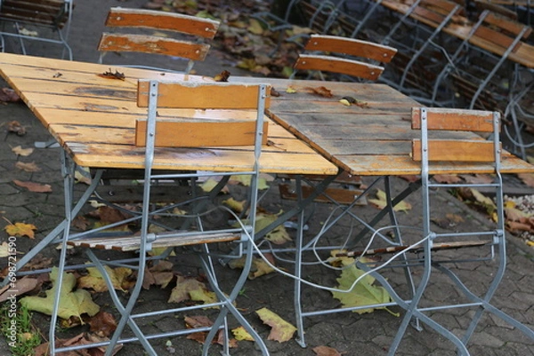 Obraz table and chairs in a garden café