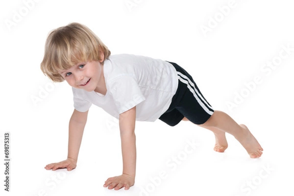 Obraz Cute boy performs gymnastic exercises