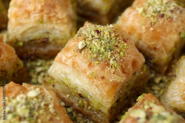 Fototapeta Delicious fresh baklava with chopped nuts on table, closeup. Eastern sweets
