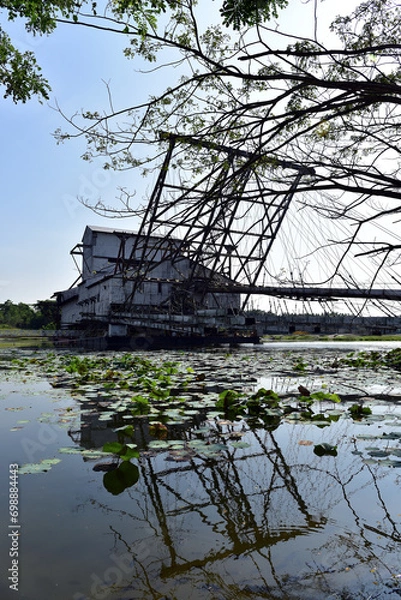 Fototapeta The last abandoned tin mining dredger during British colonial now display in Tanjung Tualang, Batu Gajah, Perak, Malaysia
