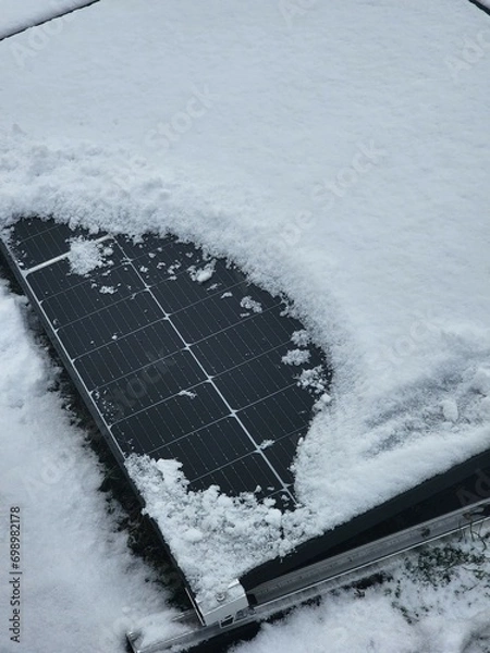 Obraz Renewable energy solar PV panels covered with white snow.