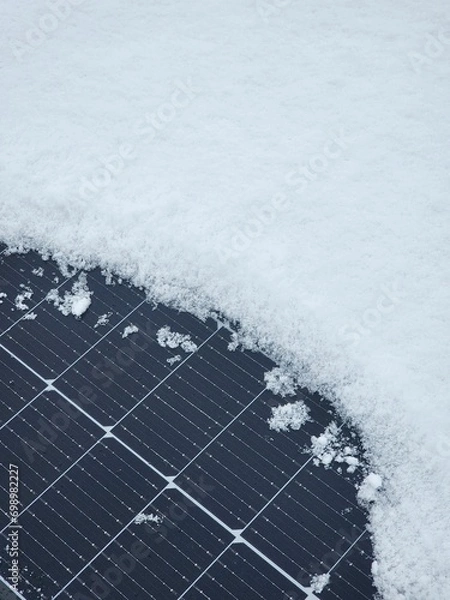Obraz Renewable energy solar PV panels covered with white snow.