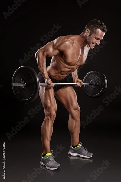 Obraz Muscular bodybuilder guy doing exercises with dumbbells