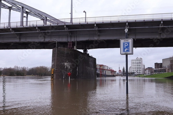 Obraz Flooding of the river Rhine, Arnhem, the Netherlands. In the background the John Frost bridge. The road is not accessible because of the high water level.