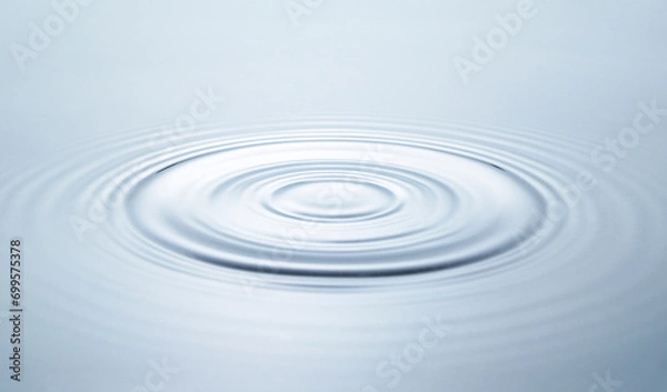 Fototapeta Blue water circles surface with rings and ripples from drop