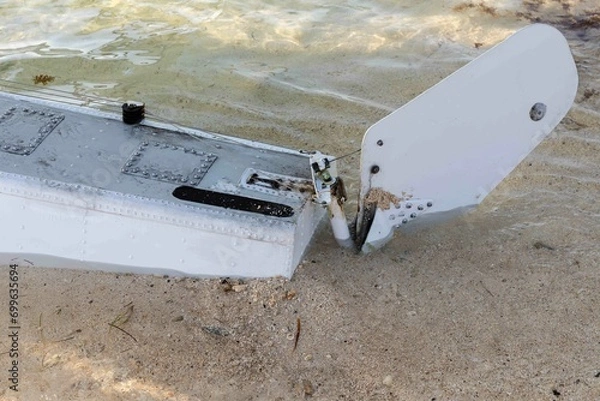 Obraz The pontoon and rudder of a float plane touches the sandy beach in Key West, Florida