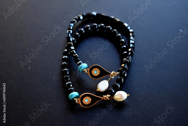 Fototapeta two black bracelets isolated on a surface