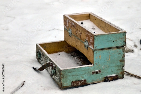 Fototapeta broken old wooden box with lock in snow