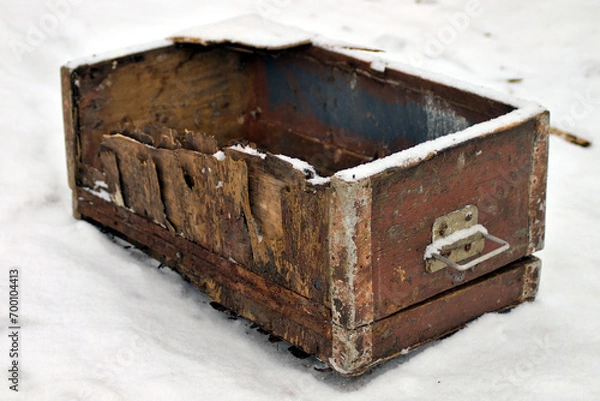 Fototapeta broken old wooden box with lock in snow