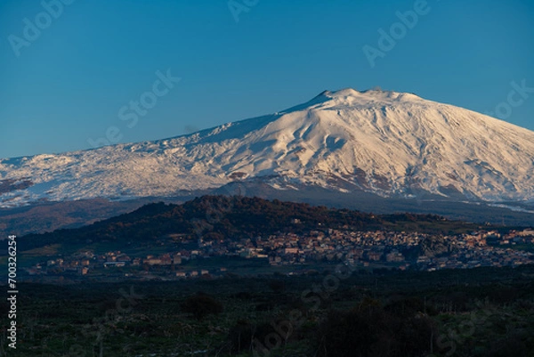 Obraz Bronte town under the snowy and majestic volcano Etna and a cloudy blue sky