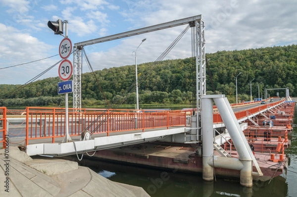 Fototapeta Pontoon bridge across the river in the summer