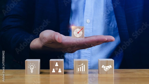 Fototapeta Hand arranging wood block stacking with business strategy and Action plan, targeting the business concept. Business development concept. Goal plan action.