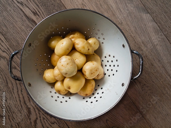 Fototapeta washed  new potatoes in a collander