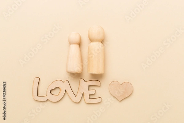 Fototapeta Wooden couple in love on color background, top view. Creative valentine's day composition