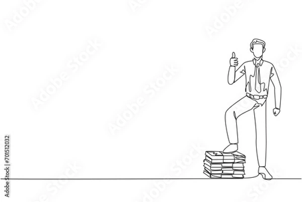 Fototapeta Single one line drawing businessman stands with thumbs up pose and steps on stack of banknotes with one of foot. Amazing feeling. Always make a profit. Continuous line design graphic illustration