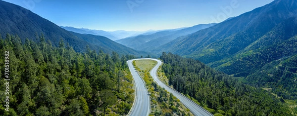 Fototapeta Aerial view of the road on the mountain with forest arround.