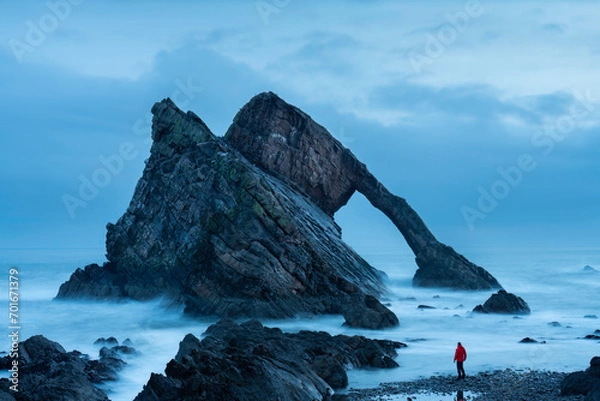 Obraz Tourist at Bow fiddle rock, Portknockie, Scotland.