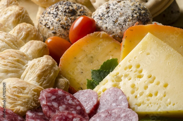 Fototapeta assorted cheeses with bread, tomatoes and sliced salami