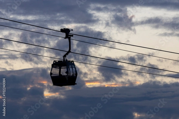 Fototapeta 2023 Dec 30,Hong Kong.Ngong Ping 360 cable car on Tung Chung ,Lantau Island, Hong Kong. Cable car just leave the Tung Chung City.