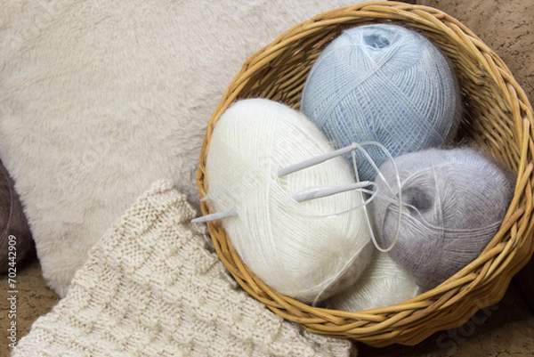 Fototapeta Materials for creativity. Knitting needles and threads. Hobby and creative leisure concept. Place for handicrafts. Selecting materials for a knitting project.