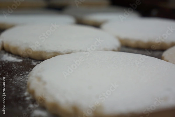 Fototapeta Flat Spanish polvorones with white powder, in tray, macro, well lit