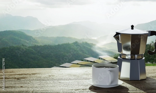 Obraz Coffee cup filled with coffee and mocha pot. Warm coffee on the table The background is nature, mountains. sunny in the morning.3D rendering