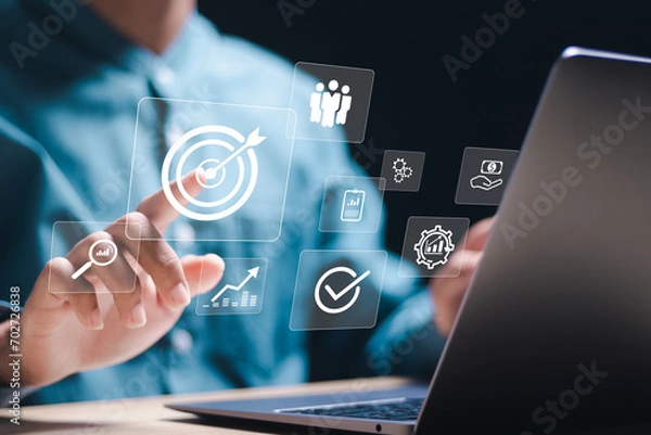 Obraz Targeting business concept. Businessman use laptop with target icons for business objective. Strategic planning for business growth and target customer group. set up business objective target goal.