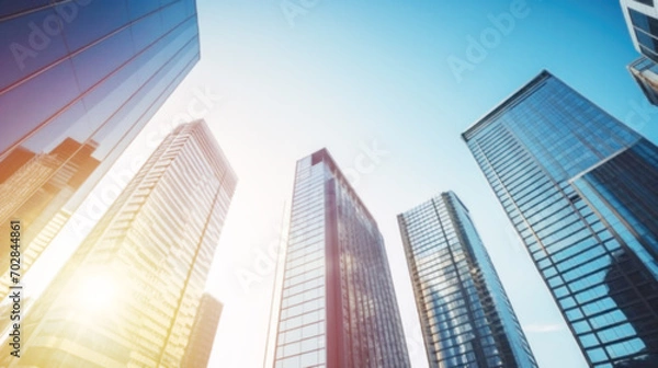 Obraz Modern office building with blue sky, and glass facades. Economy, finances, business activity concept, Eco-friendly building in the city, blurred image