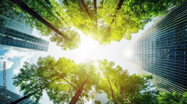 Fototapeta Eco-friendly building in the city, modern building reflects nature and, sustainable glass building for reducing heat and carbon dioxide, Office building with a green environment, Blurred image