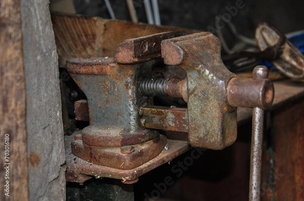 Fototapeta old bench vice. Close-up view of a mechanic's vice at the foreman's workplace.