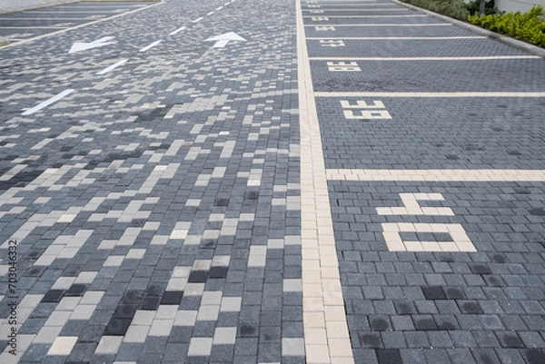 Obraz Numbering parking spaces in a parking lot car street organization. covered with street tiles surface for vehicles. parking facility.
