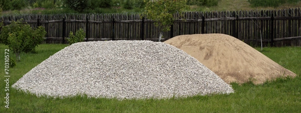 Fototapeta Heaps of sand and broken stone on the grass