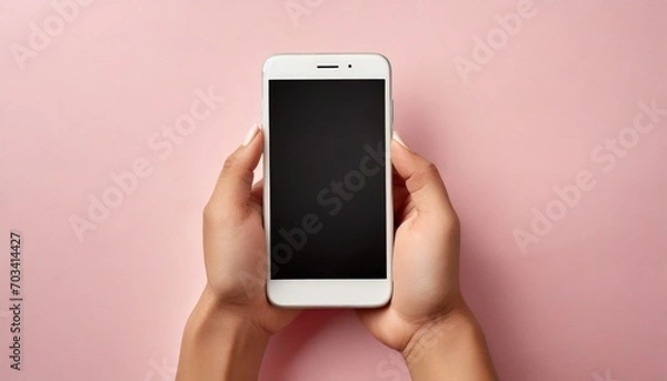 Fototapeta Hand using smartphone with blank screen, isolated on pink background	
