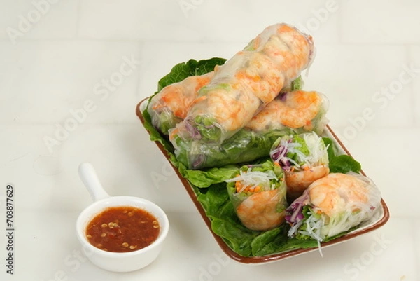 Fototapeta Fresh spring rolls with shrimp in rice paper. Rice paper rolls with shrimp, rice noodles,vegetable salad and sauce.