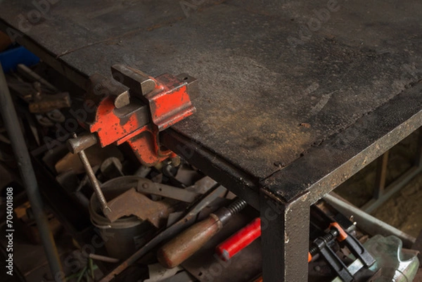 Obraz A small vise is fixed on the work table
