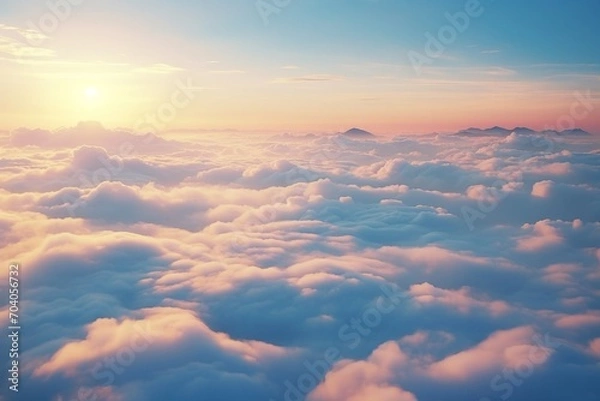 Fototapeta peaks showing above a a sea of clouds at sunset sky with sun hiding in the horizon