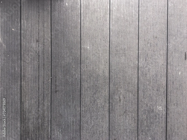 Fototapeta Abstract design with a mix of light and dark wooden planks forming a unique pattern.