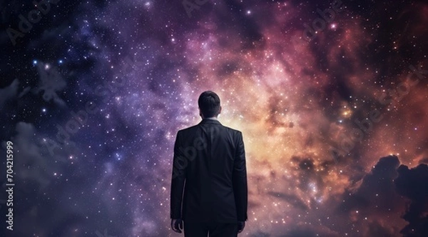 Fototapeta abstract of Businessman's Vision for the Future,  silhouette of businessman in a suit observing the light of space, man looking at a star in outer space concept