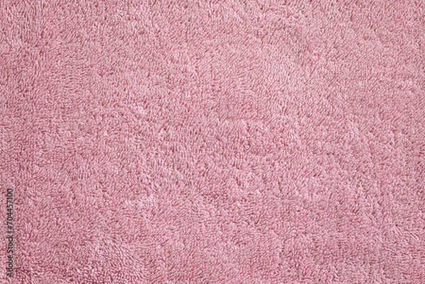 Fototapeta Background surface of a pink, soft, terry, textured towel close-up