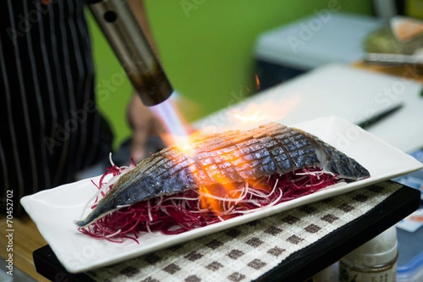 Obraz Chef sushi using a torch.