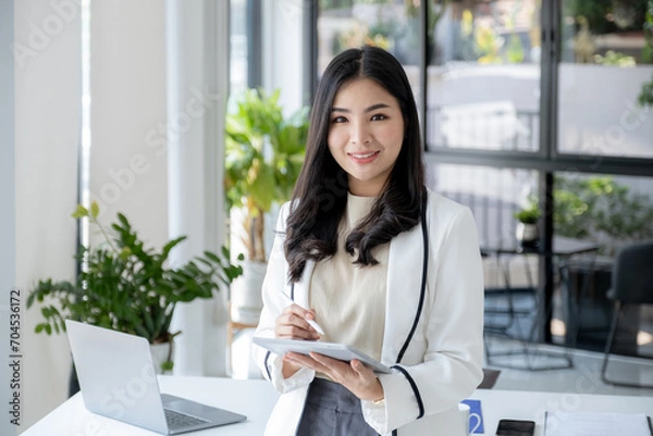 Fototapeta Successful businesswoman financier investors use tablet to communicate remotely over the internet or video call to set challenging business goals and ready to achieve targets from home office