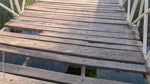 Obraz Old row of wooden steps across the river