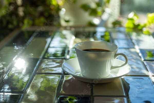 Fototapeta Cup of hot coffee on a table,