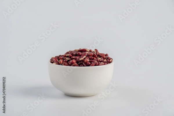 Fototapeta Red kidney beans in white cup on white background