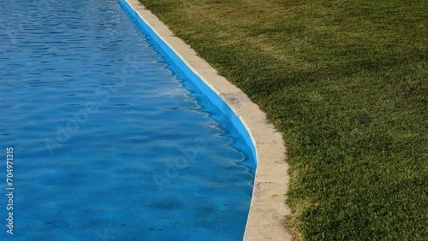 Obraz swimming pool and grass area as background