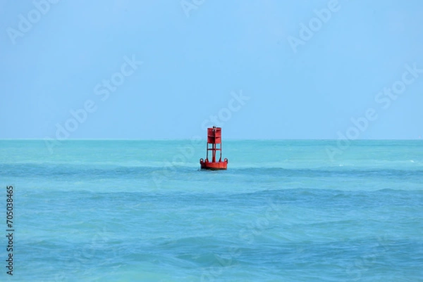 Fototapeta An isolated red ocean buoy. Channel marker. Nautical signage.