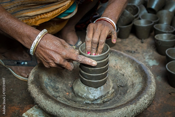 Fototapeta Pottery making involves shaping clay by hand, using a wheel, or coiling techniques.